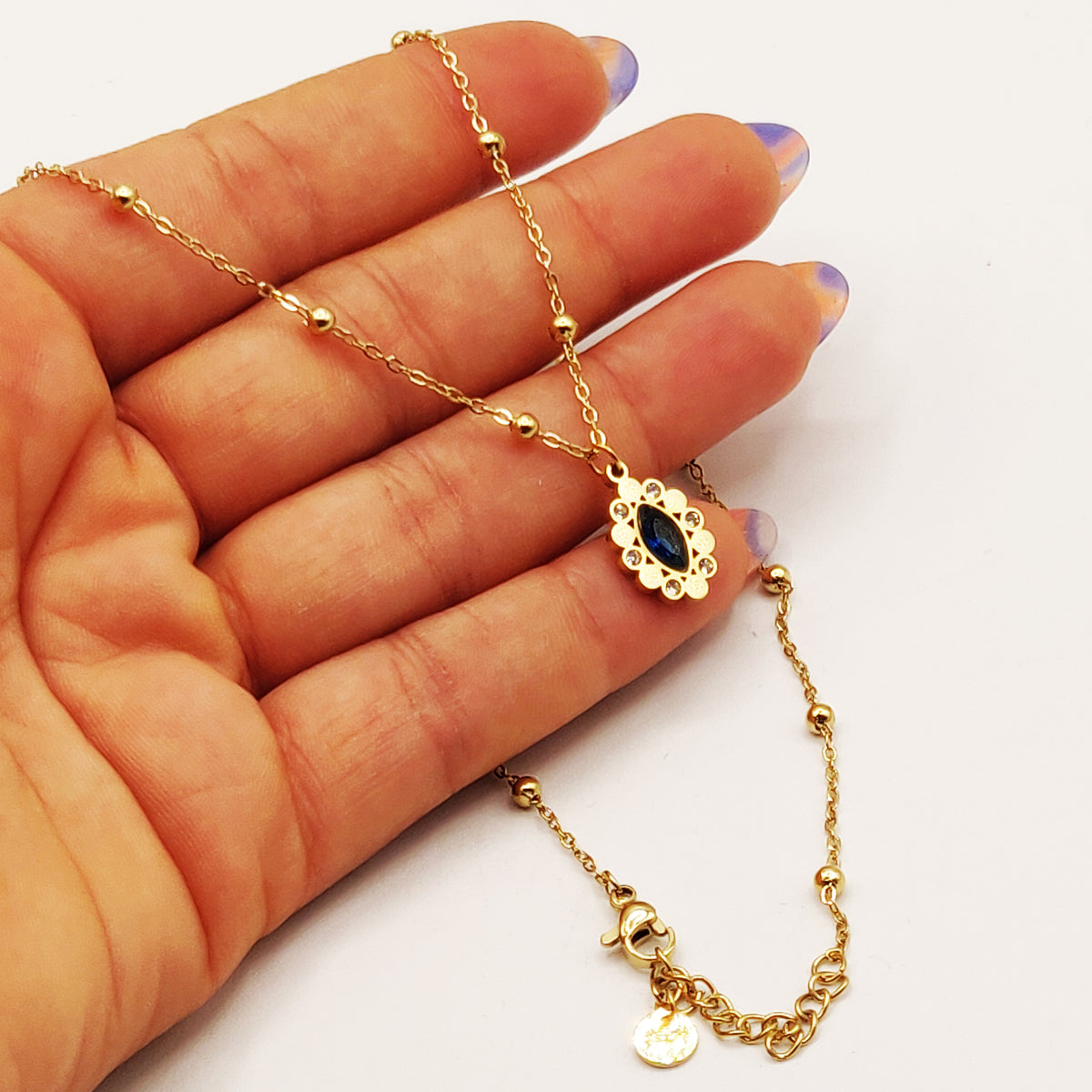 Collier Multi Perles Dorées et Cristal Bleu Ovale Luxe